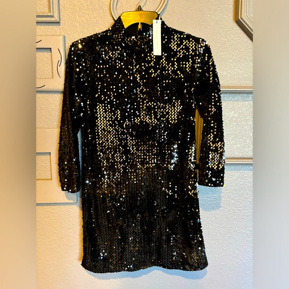 Black sequined mock neck mini dress.